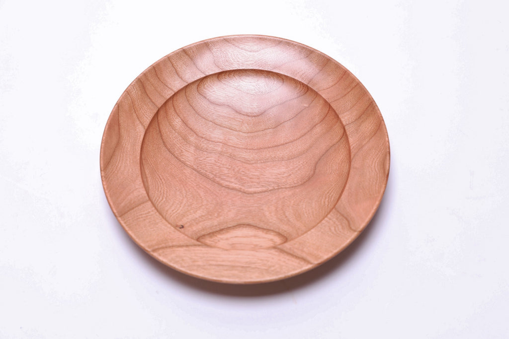 Black cherry ring dish interior showing faint quilt figure and natural grain patterns
