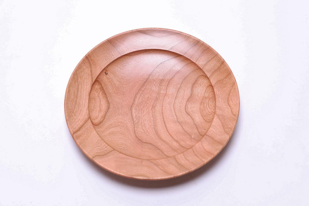 Curly wild cherry wooden ring dish top view highlighting amber and gold tones with picture frame-like rim