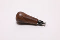 Black walnut burl wine bottle stopper showing copper undertones and chocolate tones with stainless steel base