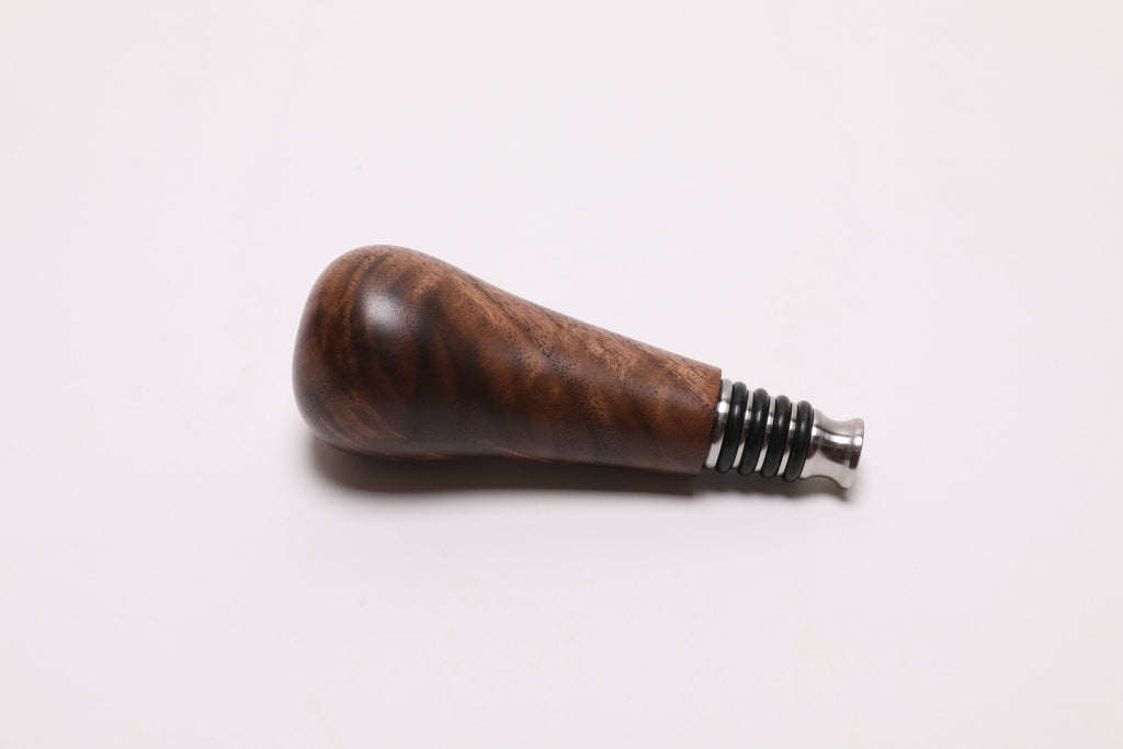 Handcrafted walnut burl wine stopper side view displaying natural wood grain and food-safe oil finish