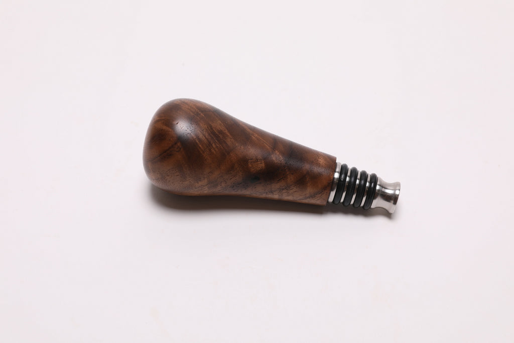 Walnut burl wooden wine stopper top view highlighting lush burl pattern and natural wood character