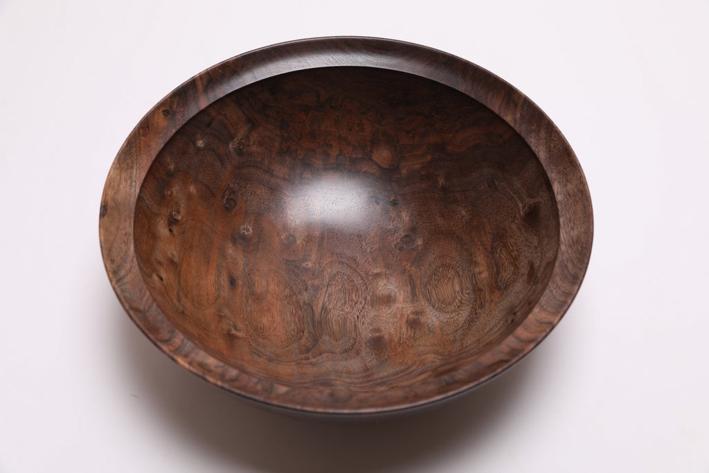 Curly walnut wooden bowl top view highlighting chatoyant bud scars and figured grain character