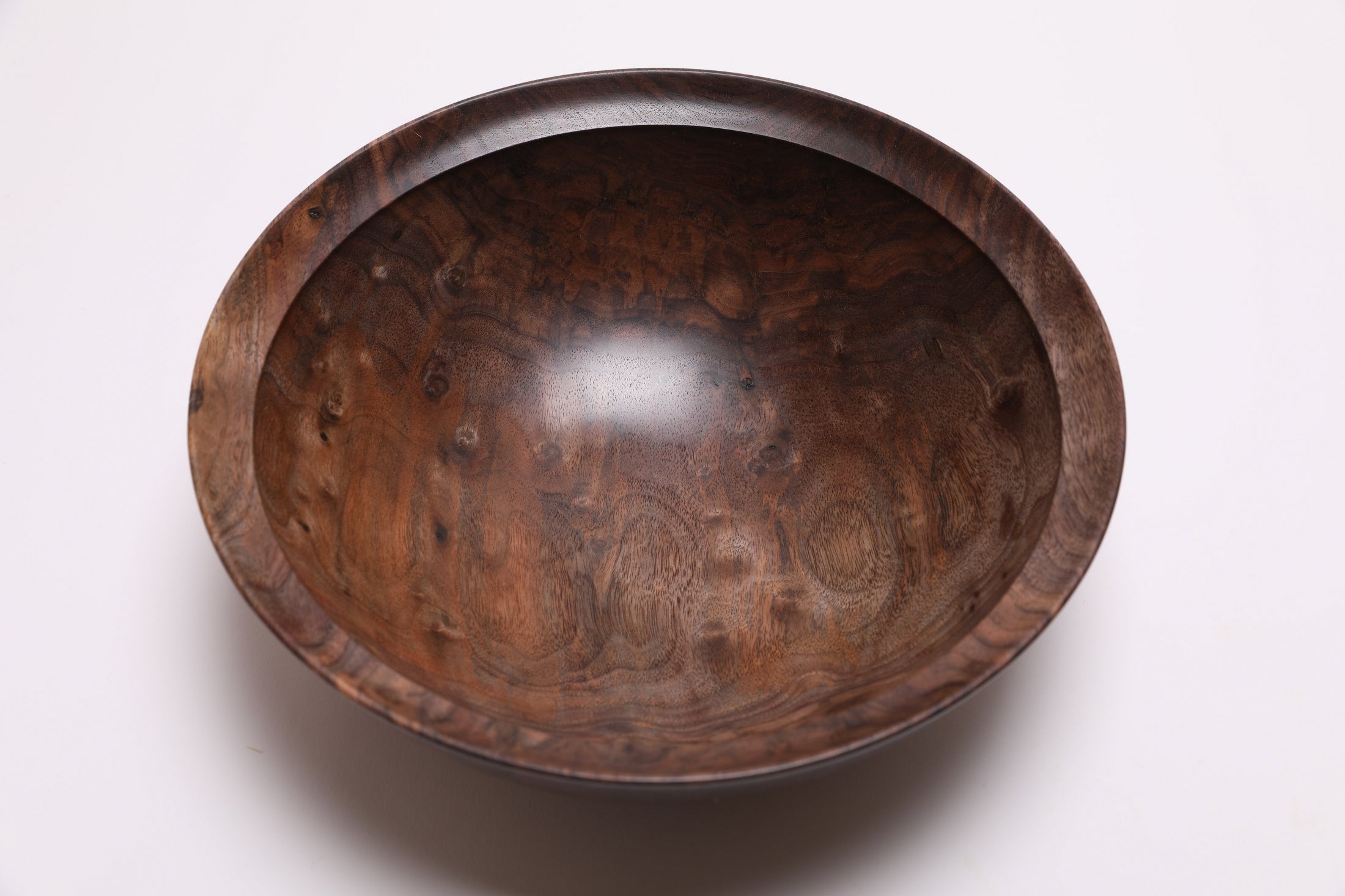 Curly walnut wooden bowl top view highlighting chatoyant bud scars and figured grain character