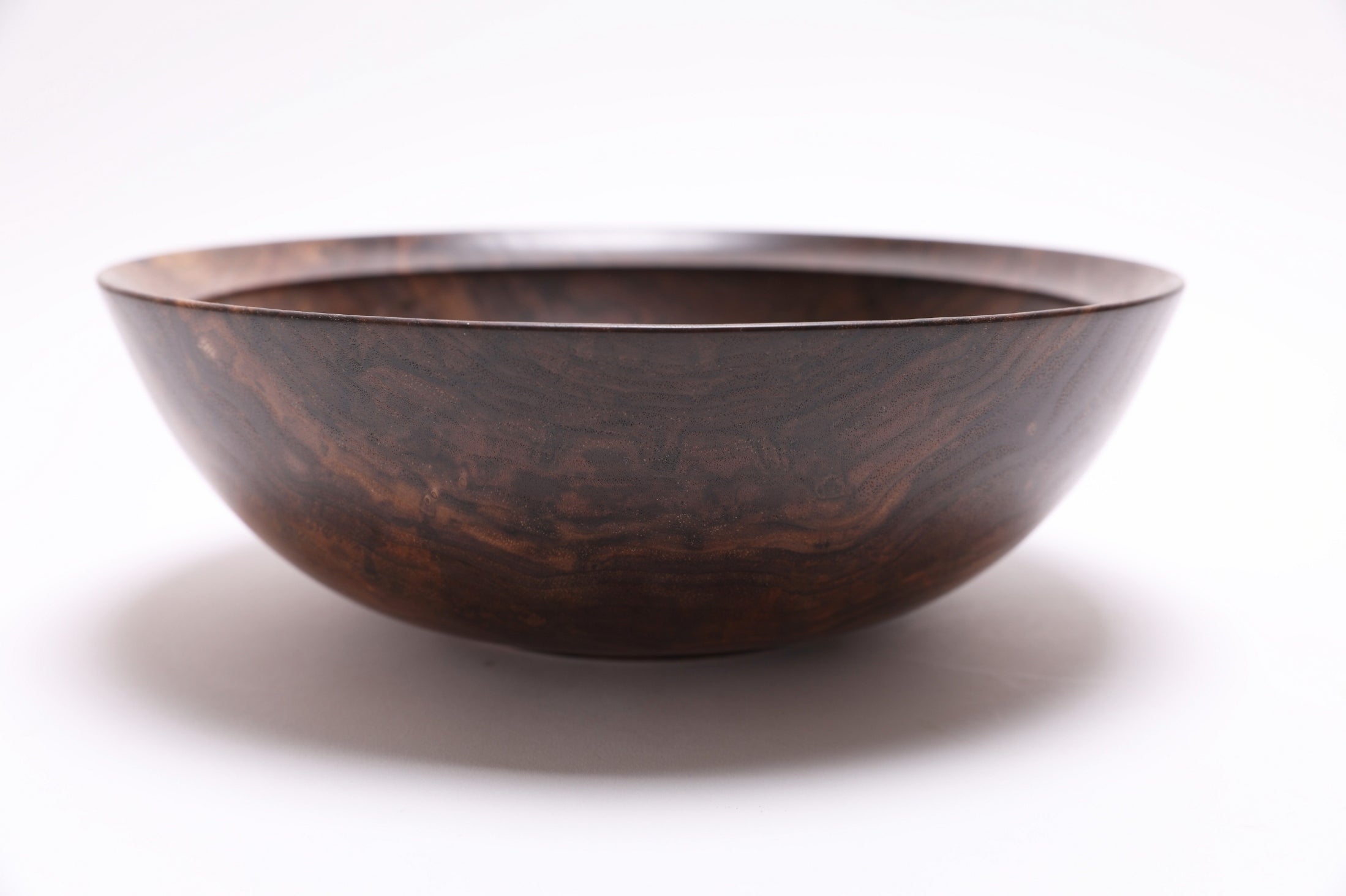 Handcrafted wild walnut bowl 10 1/2 x 3 1/2 inches showing spectacular curly heartwood patterns
