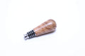 Big leaf maple burl wine stopper showing quilted figure and sand and amber coloration with stainless steel base