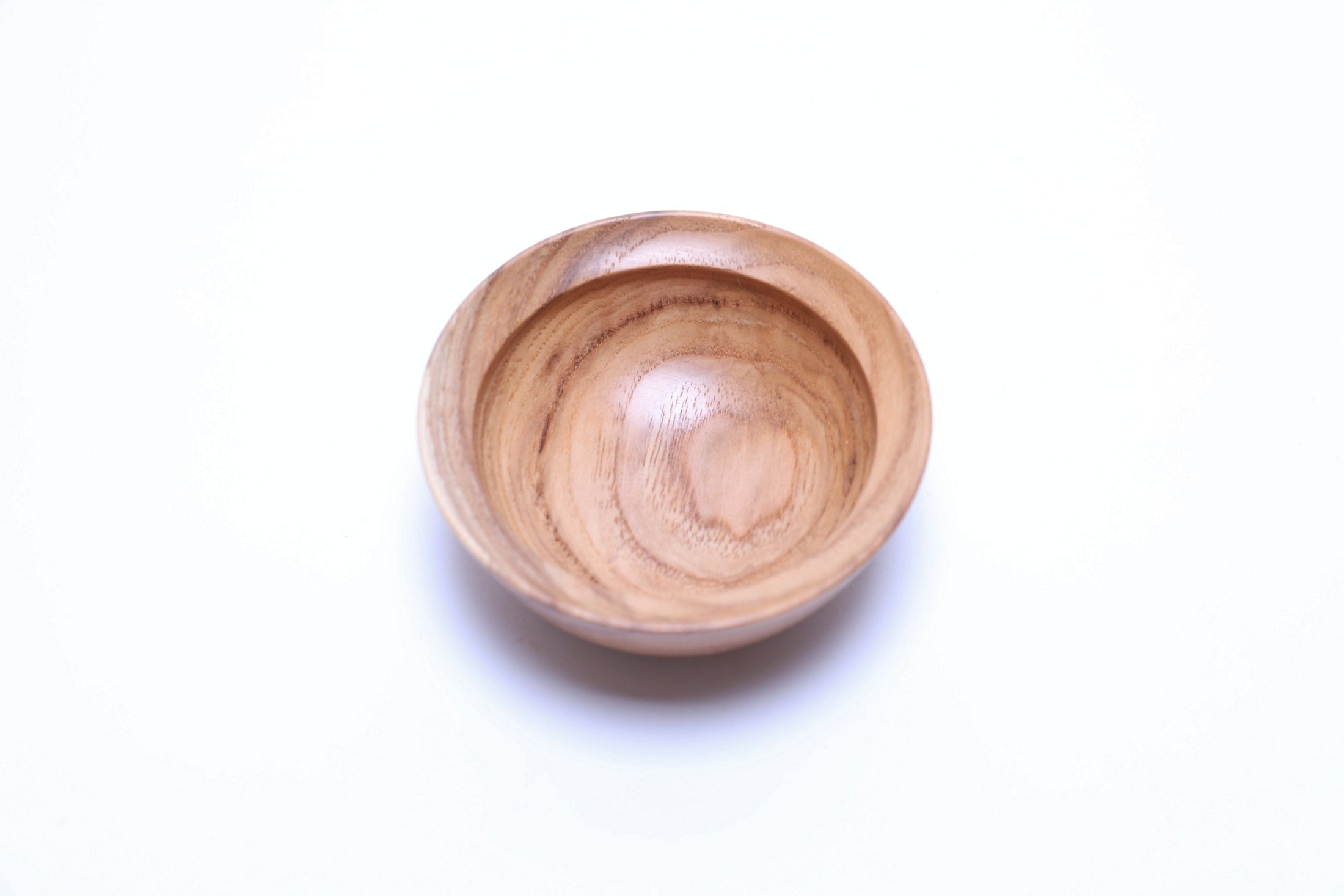 Small hickory bowl interior showing centered growth rings and natural oil finish