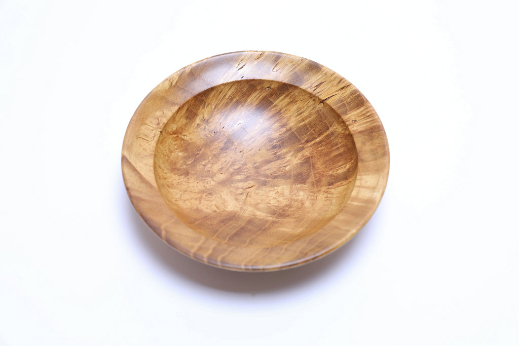 Handcrafted mulberry burl bowl side view displaying 1 1/2 inch depth and curved taper