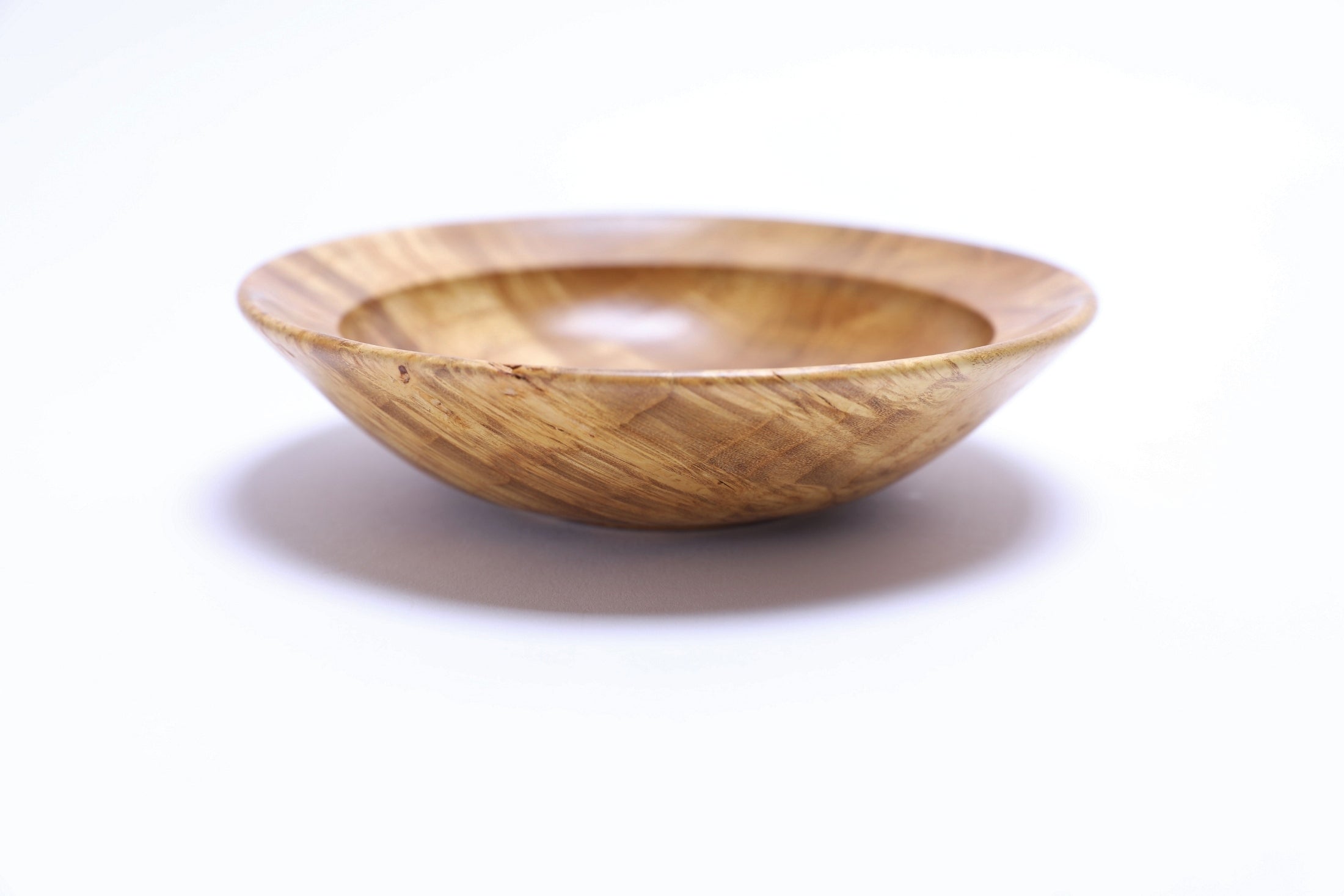 Handcrafted mulberry burl bowl highlighting fantastic ray figure