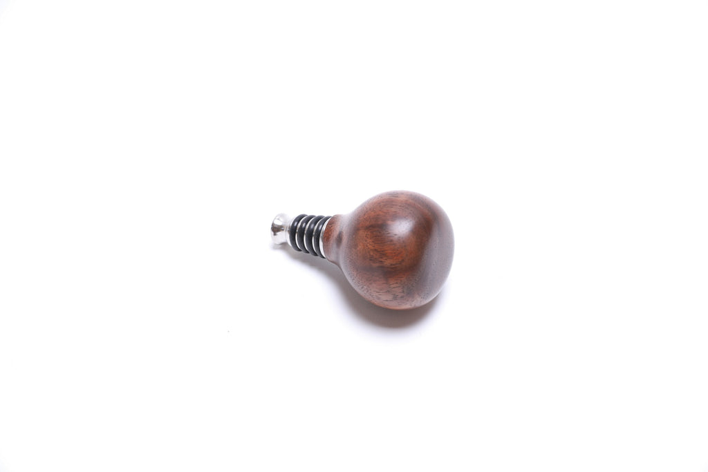 Handmade walnut burl stopper angle view showing food-safe natural oil finish and craftsmanship
