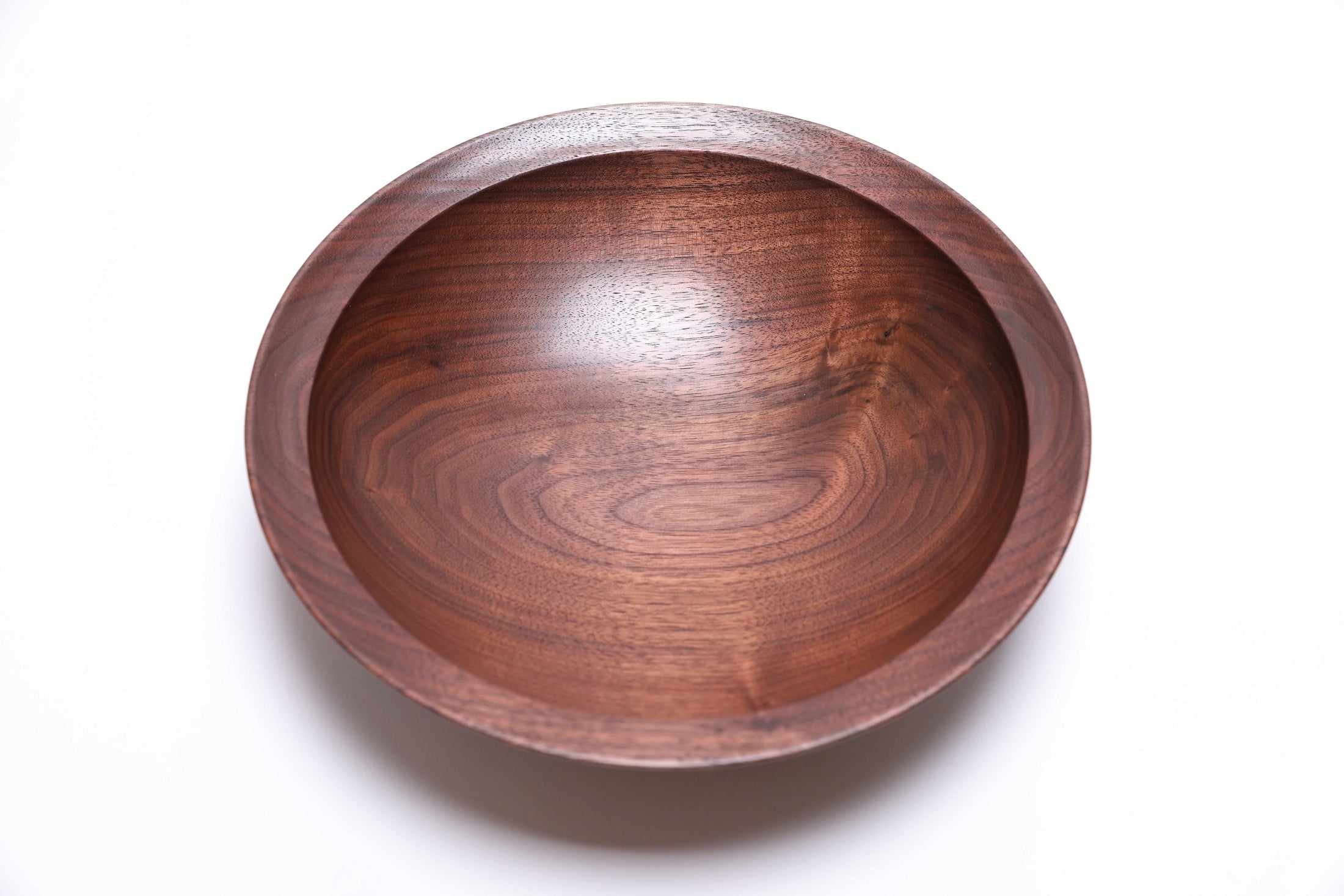 Wild walnut wood bowl interior showing milk chocolate and dark chocolate growth ring transitions