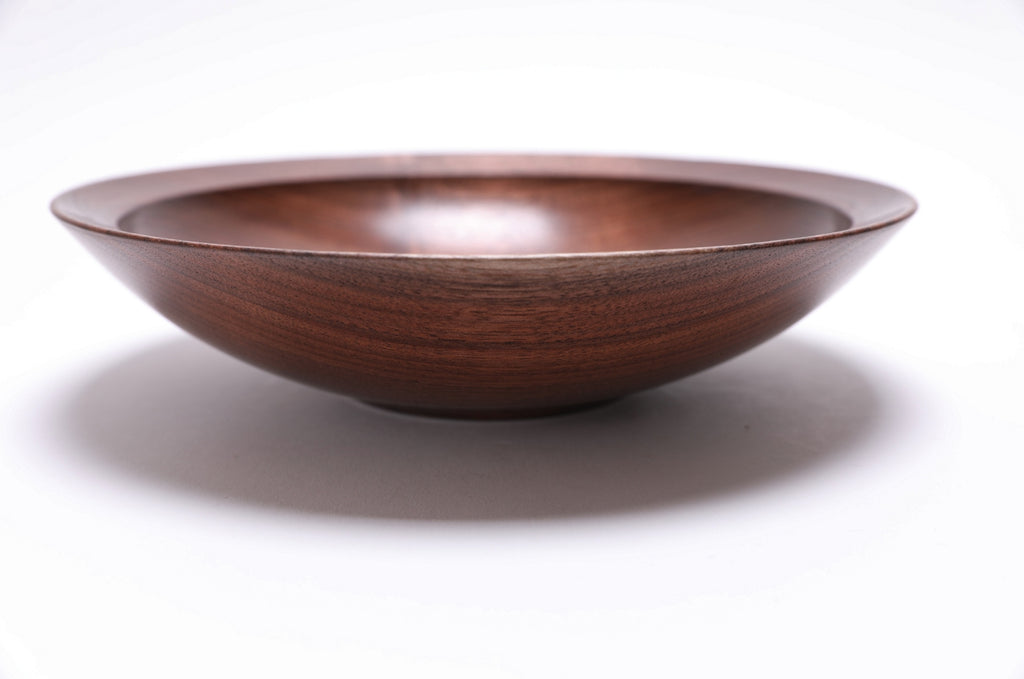 Wild walnut wooden bowl detail highlighting red undertones and growth ring pattern