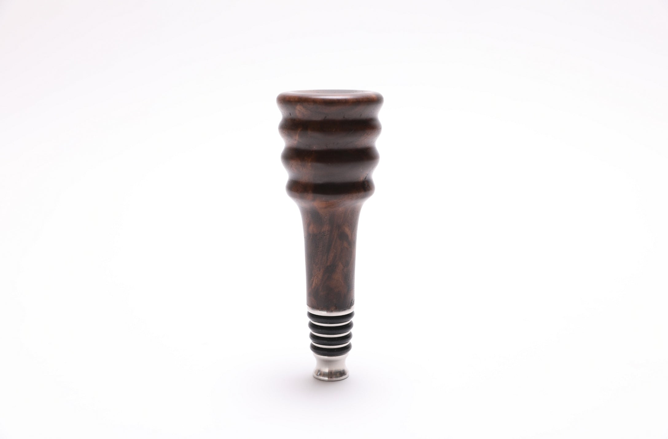 Close-up of claro walnut burl wine stopper showing natural wood grain and figure