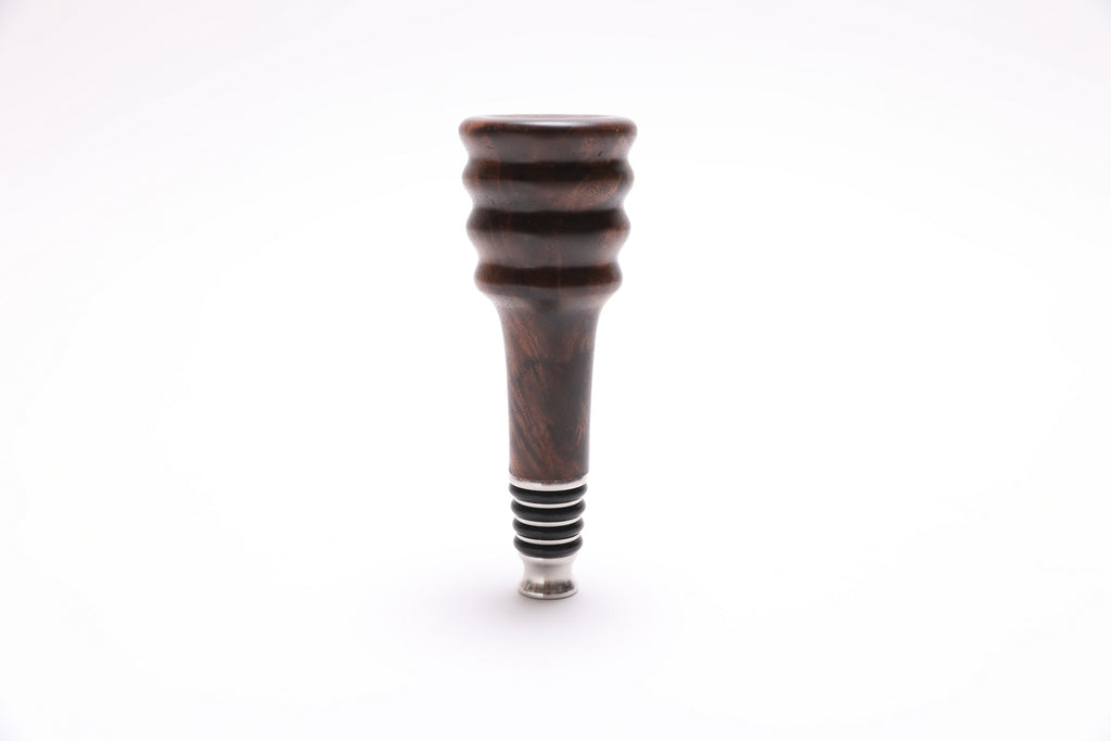Side view of handmade claro walnut burl wine stopper with stainless steel base