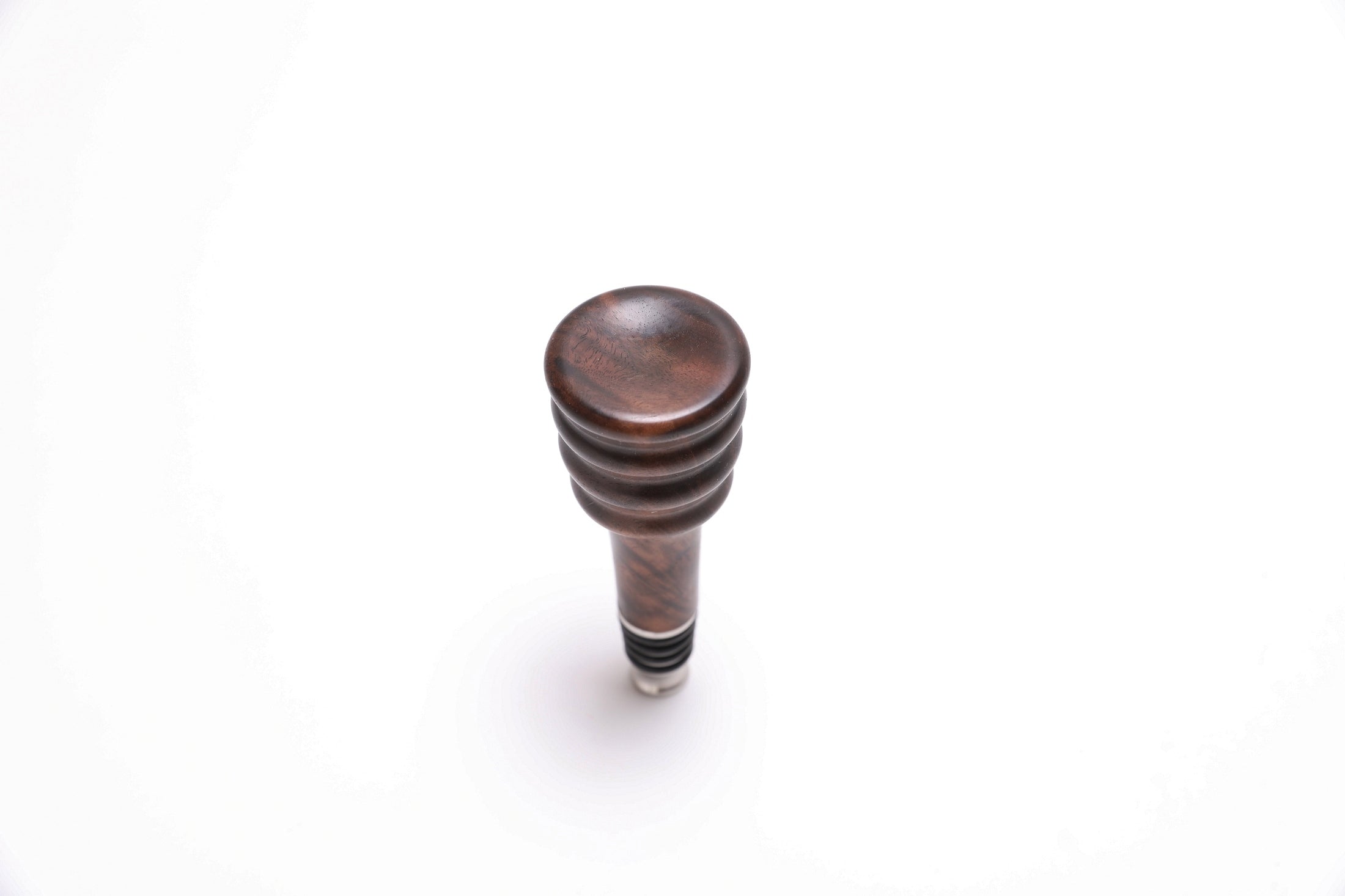 Top view of claro walnut burl wine stopper showing unique wood patterns