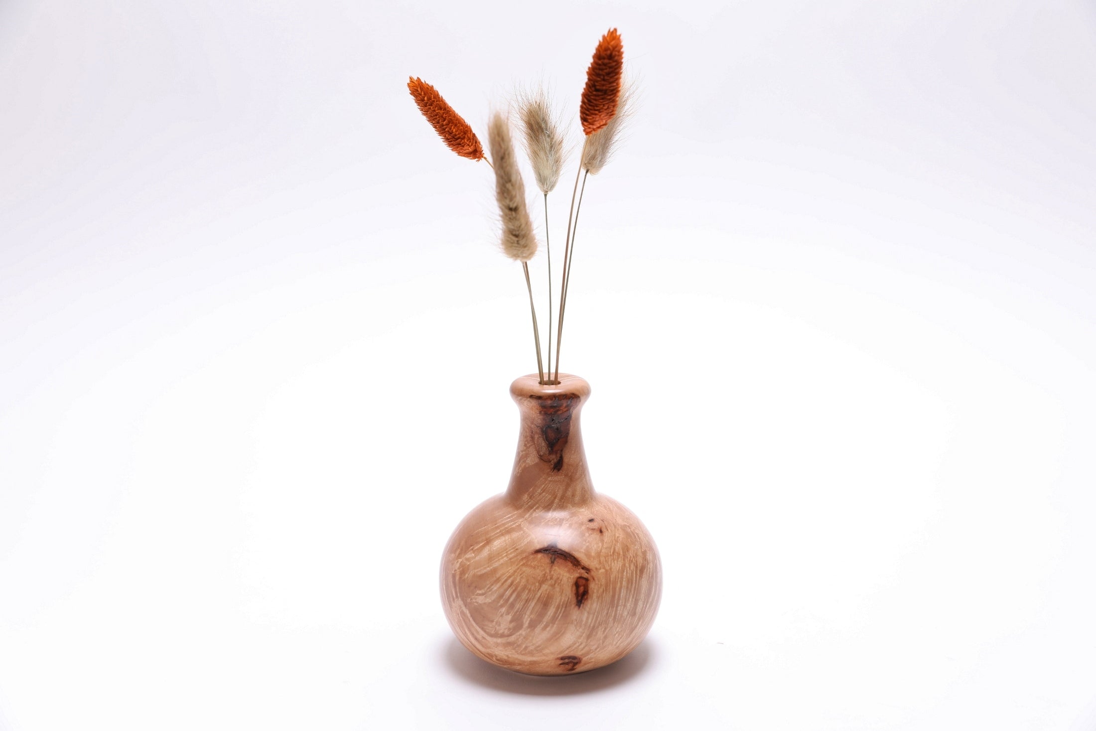 Big leaf maple burl weed pot with swirling rays and bark inclusions, handcrafted by Sanders Woodworking