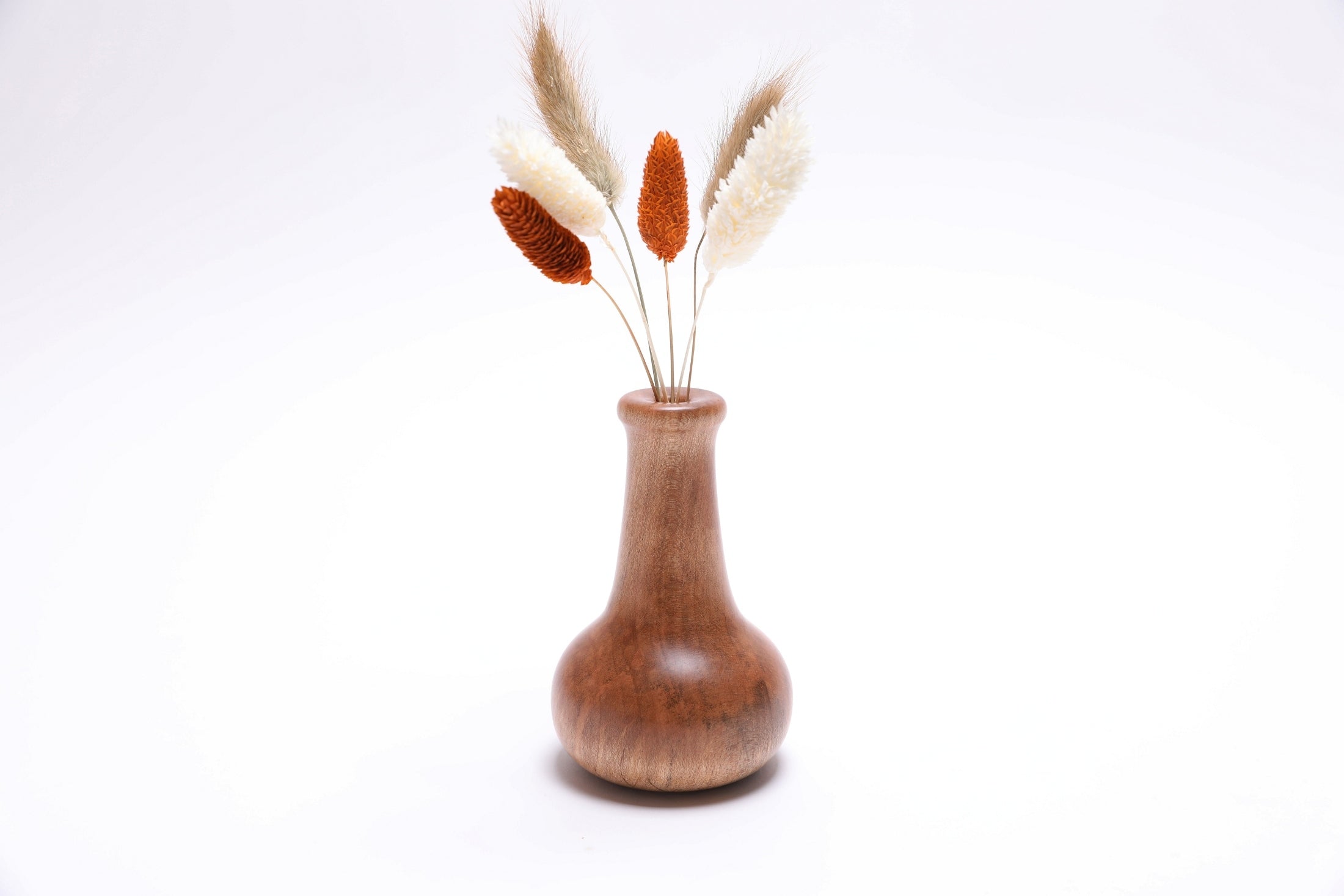 Handcrafted ambrosia maple dry vase showing natural wood grain and dried flowers