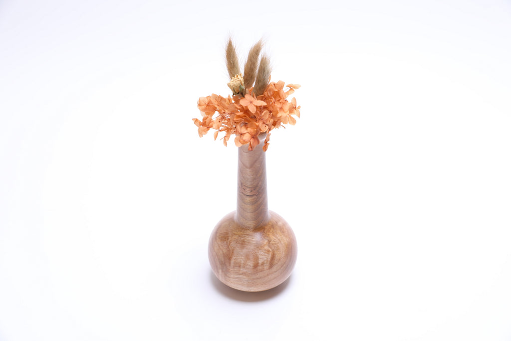 Big leaf maple burl weed pot with dried flowers and swirling grain patterns, handcrafted by Sanders Woodworking