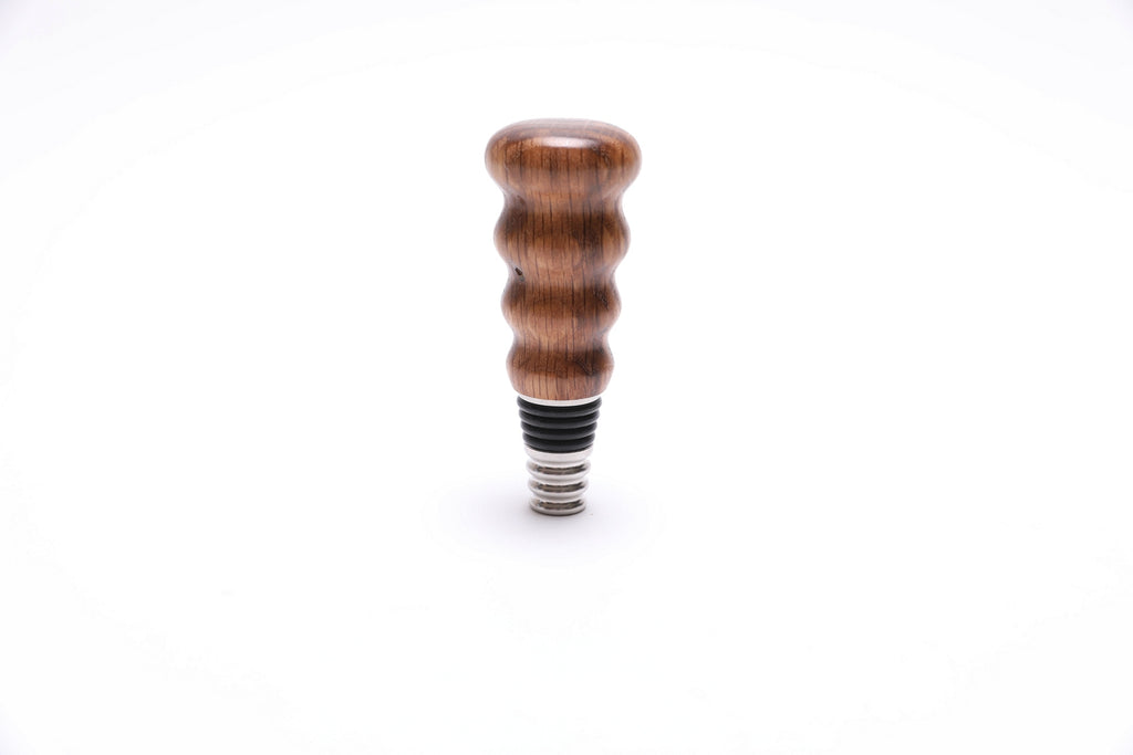 White oak wine bottle stopper with natural wood grain, handcrafted by Sanders Woodworking