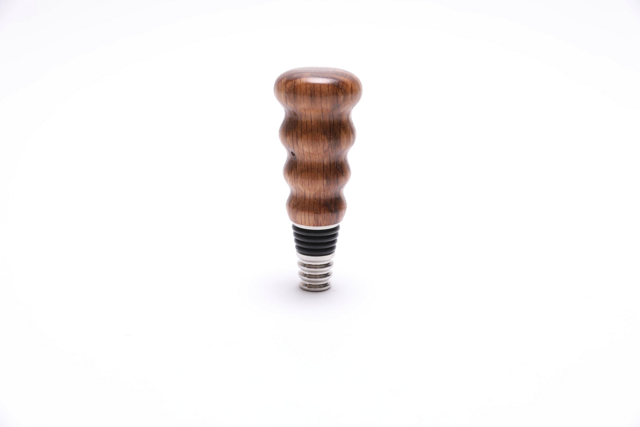 White oak wine bottle stopper with natural wood grain, handcrafted by Sanders Woodworking