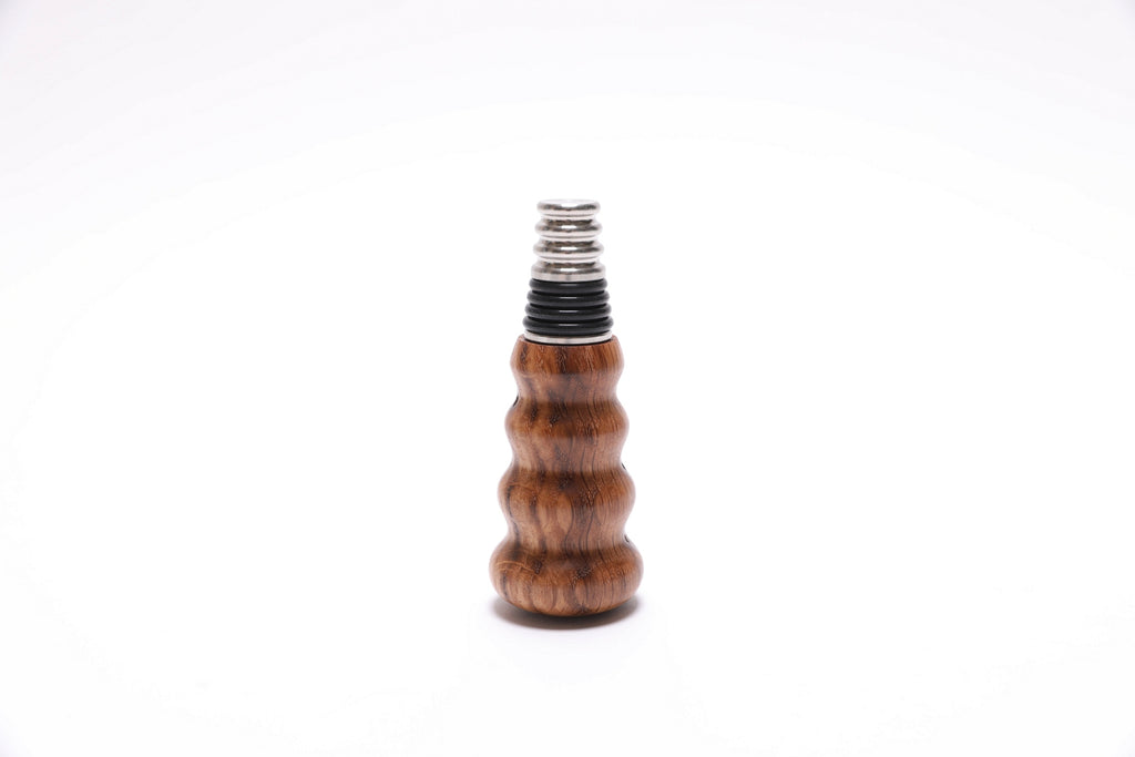 Handcrafted white oak wine stopper showing natural wood figure and grain patterns
