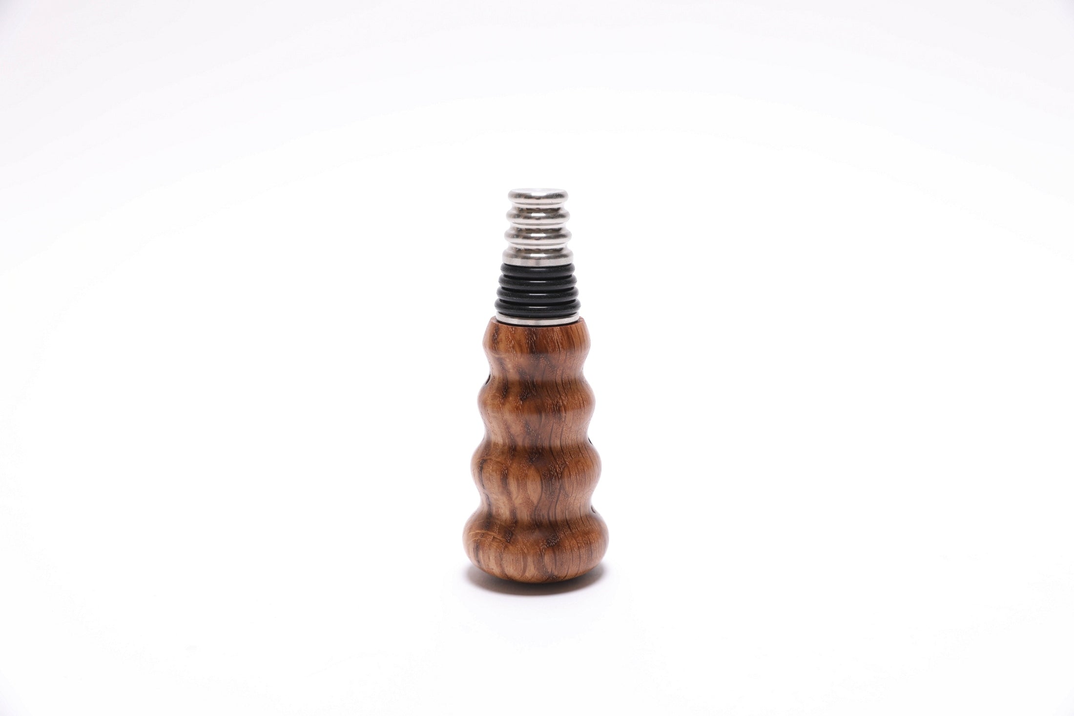 Handcrafted white oak wine stopper showing natural wood figure and grain patterns
