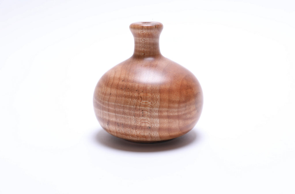 Side view of tiger big leaf maple weed pot highlighting unique striped wood grain
