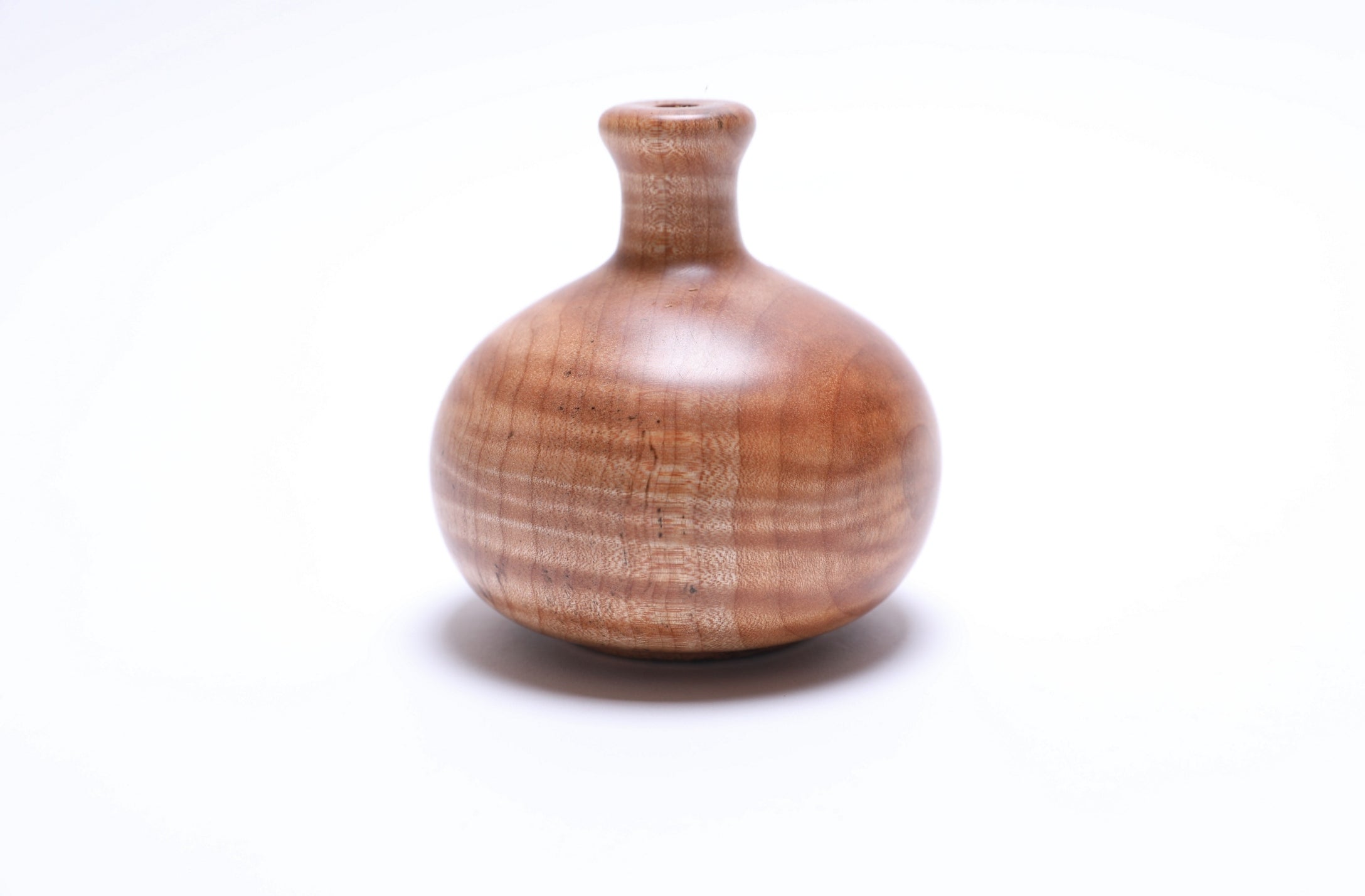 Side view of tiger big leaf maple weed pot highlighting unique striped wood grain