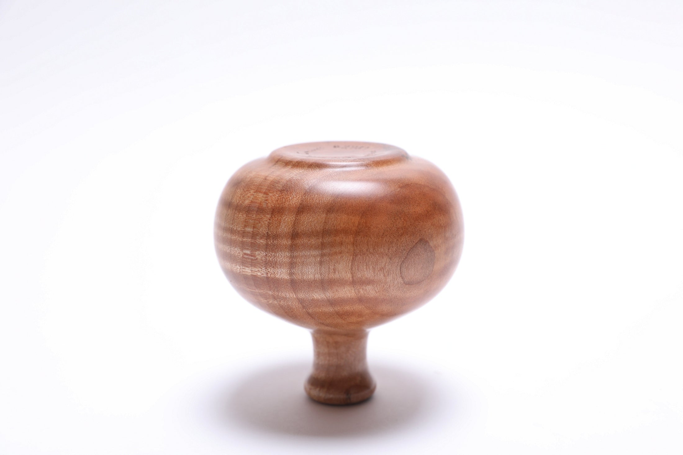 Upside down view of tiger maple dry vase with bold striped figure highlighting the raised foot base, handmade in USA