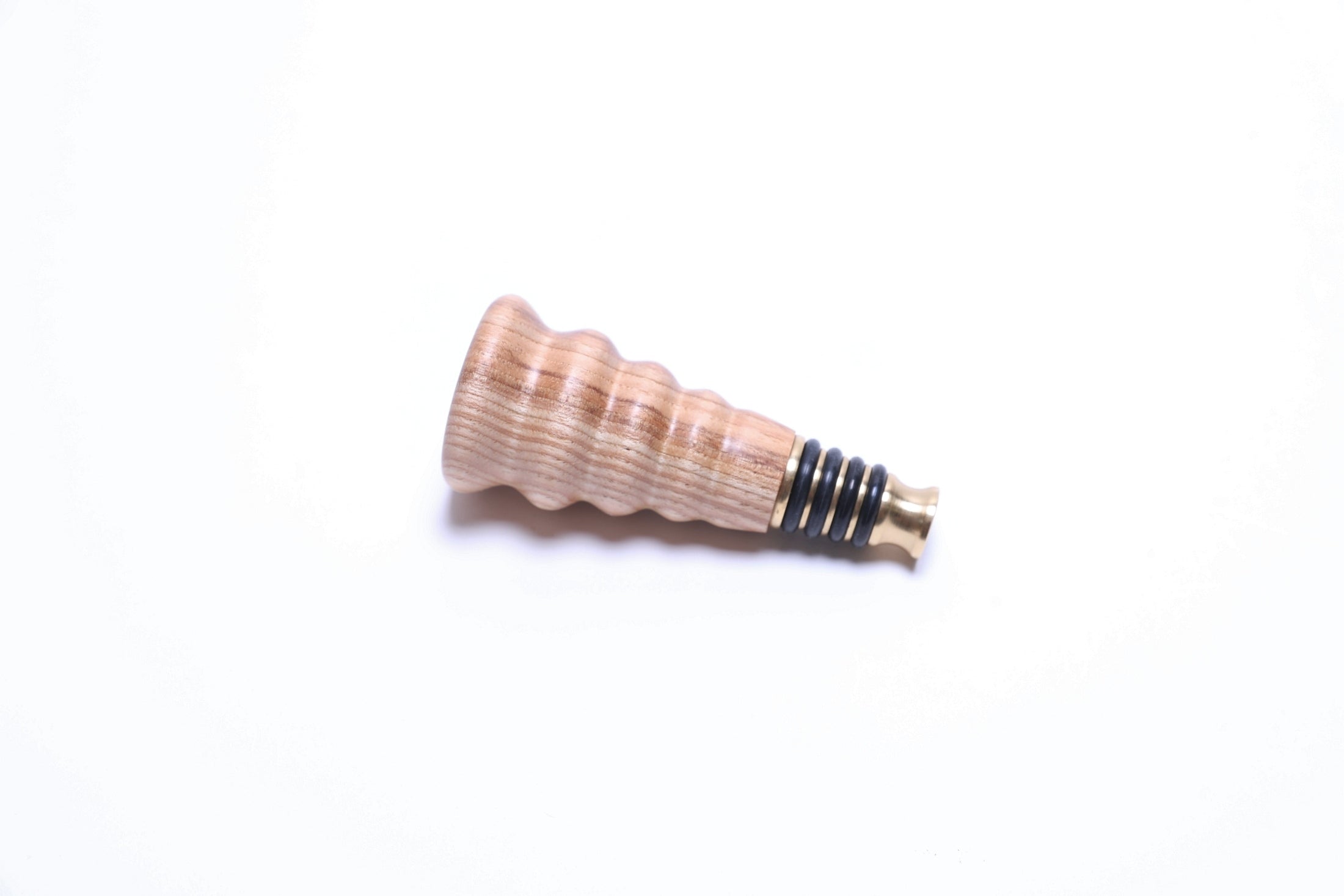 Hickory wine stopper with natural wood grain, handcrafted by Sanders Woodworking
