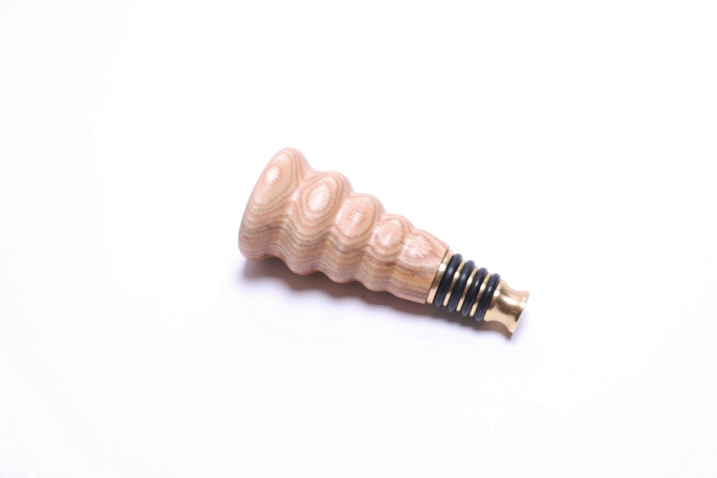 Handcrafted hickory wood wine stopper showing natural grain patterns