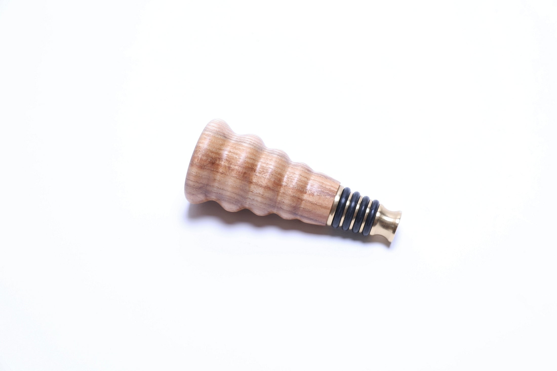 Side view of hickory wine stopper with premium solid brass base
