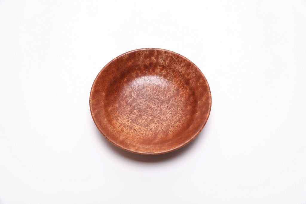 Detail of chatoyant pommele sapele wood texture and natural finish