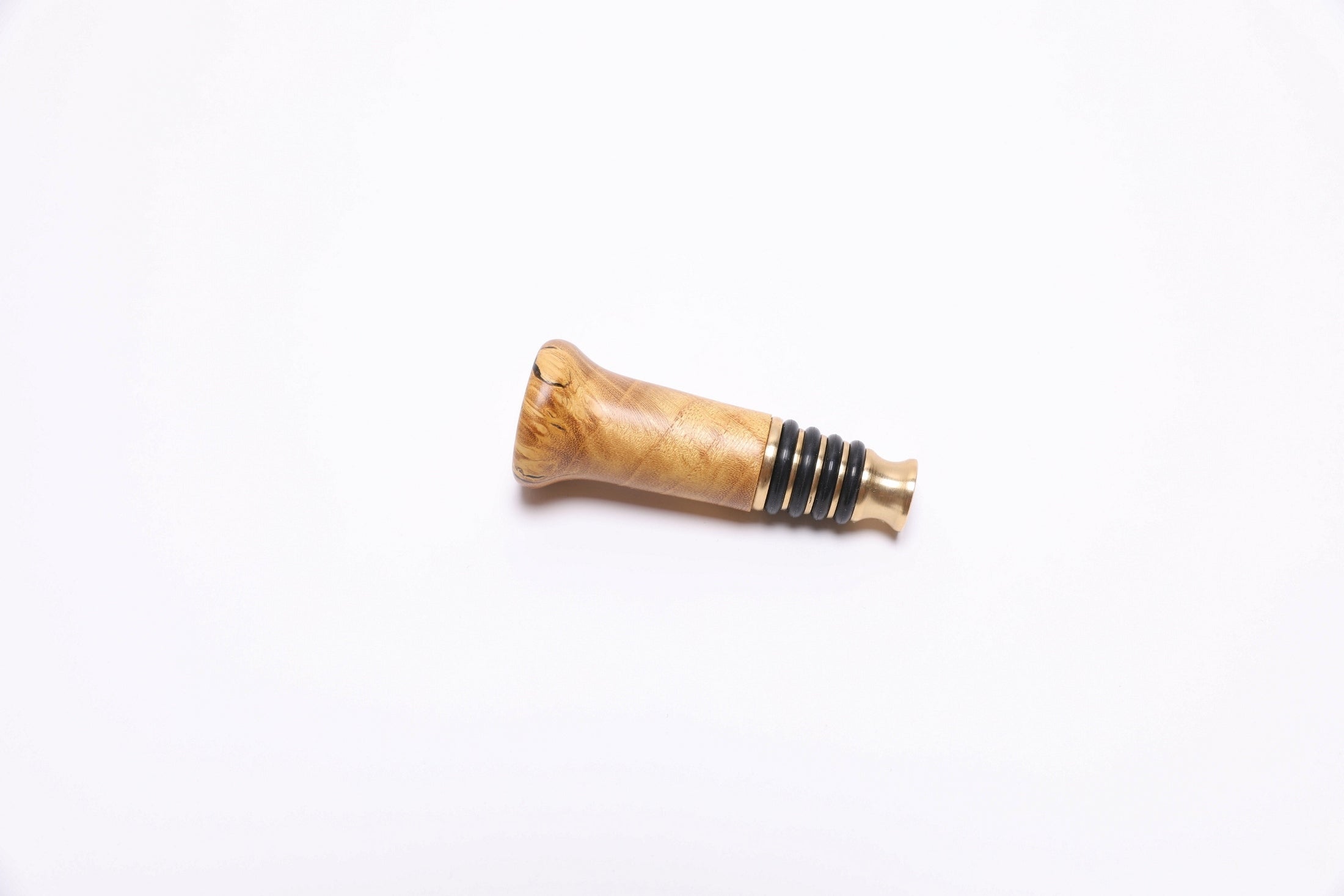 Side view of handcrafted mulberry burl bottle stopper showing swirling burl figure
