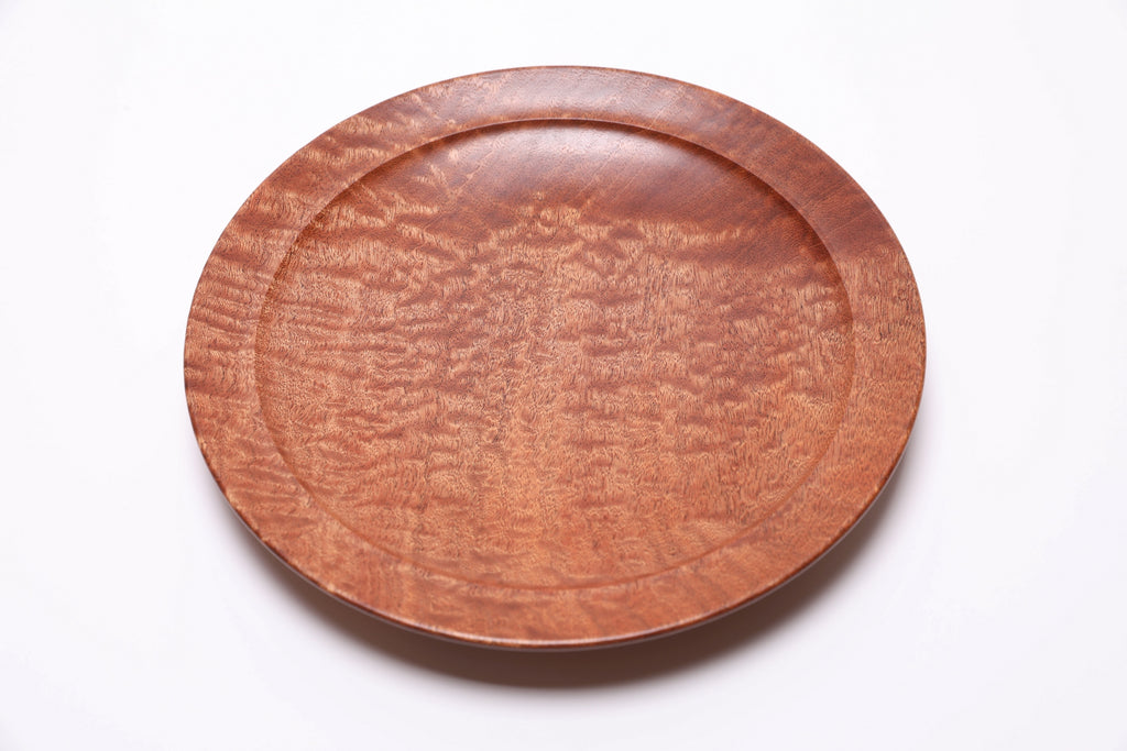 Top view of pommele sapele wooden bowl showing dramatic chatoyant shimmer and dappled pattern