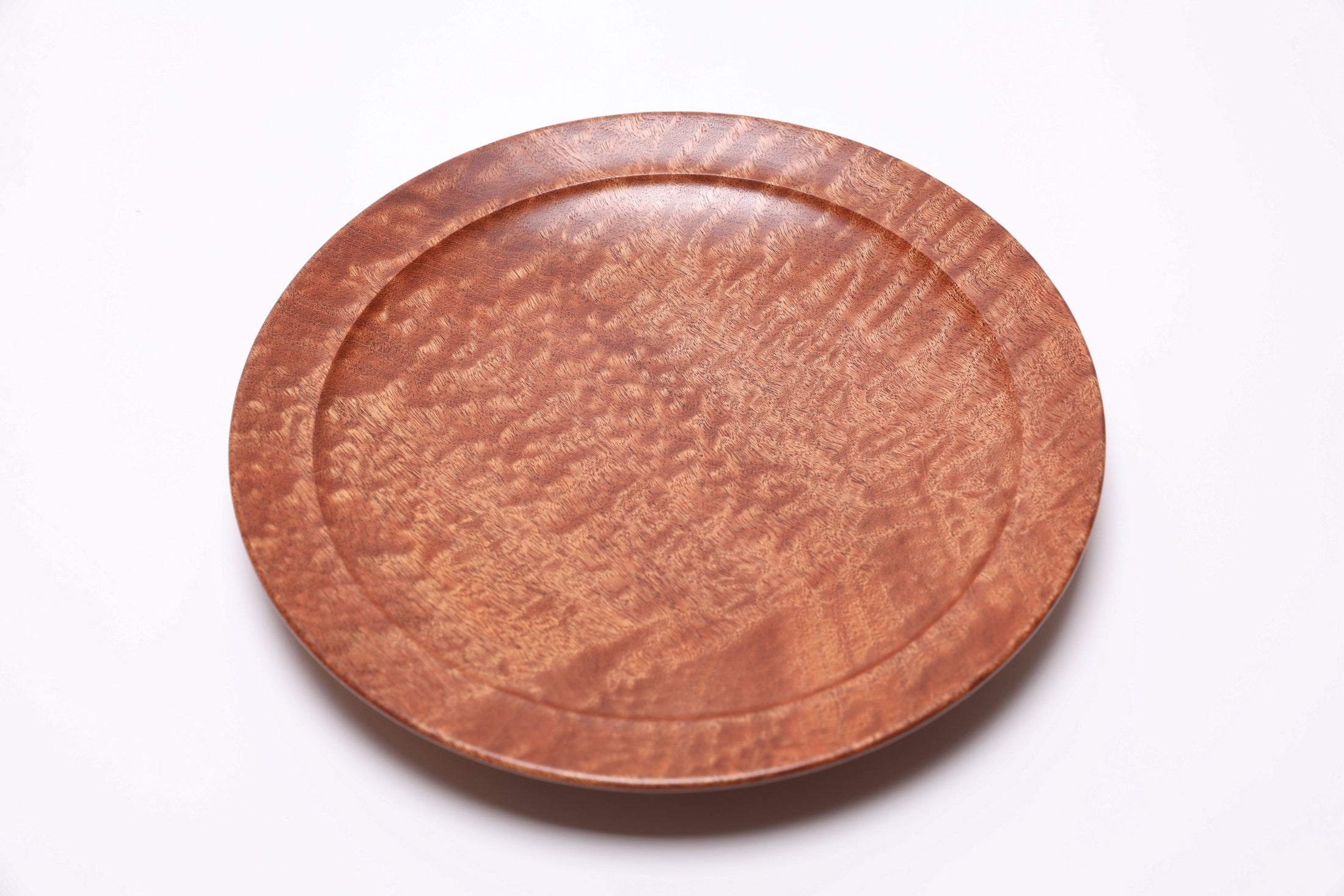 Pommele sapele bowl at angle showing curved taper and rounded over rim