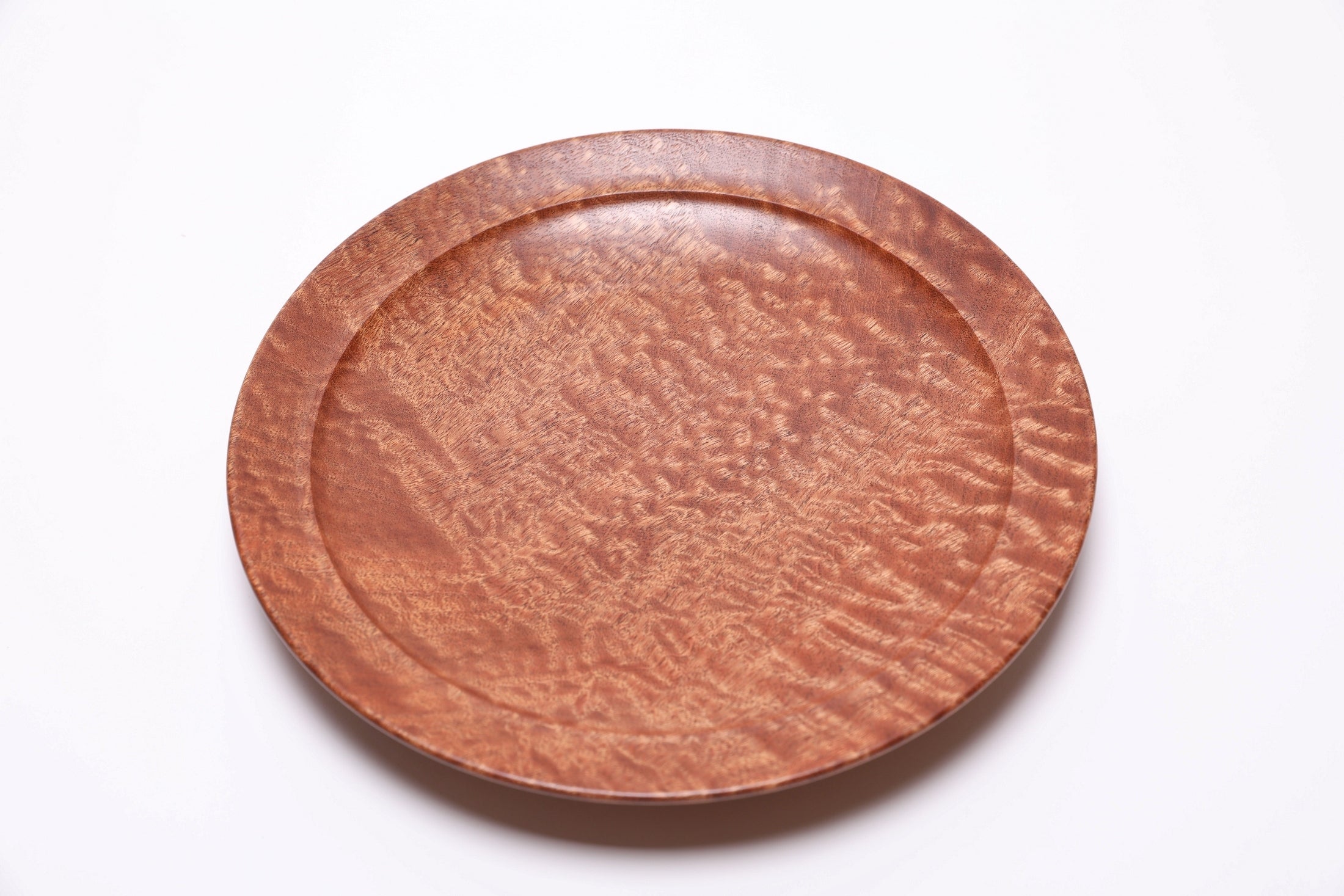 Handmade African sapele wooden bowl with raised foot and artisan craftsmanship