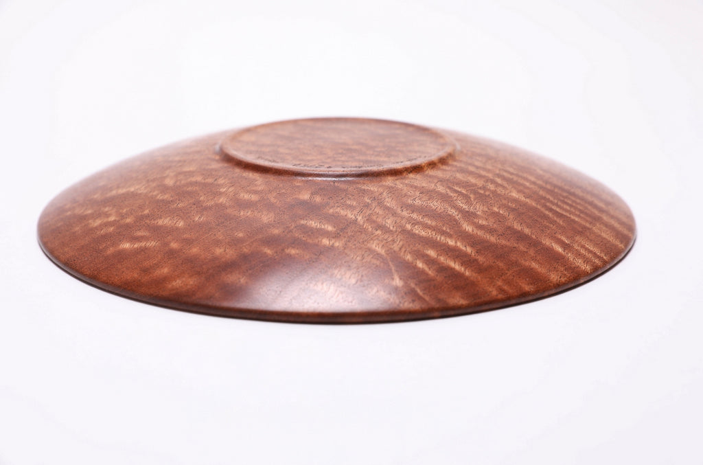 Upside down view of artisan-crafted pommele sapele bowl showing raised foot - handmade in NC 