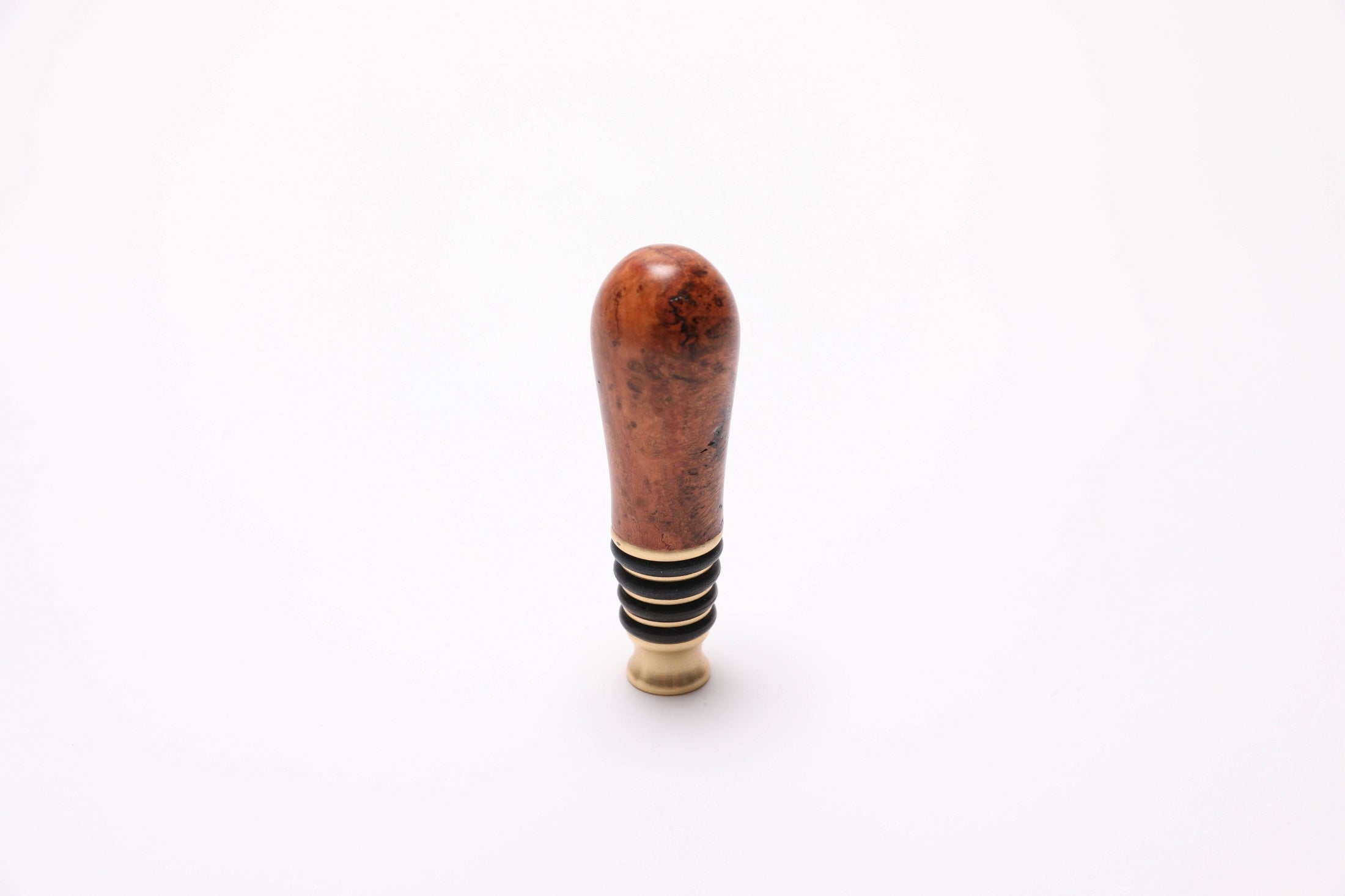Top view of black cherry burl bottle stopper showing swirling burl and birdseye pattern