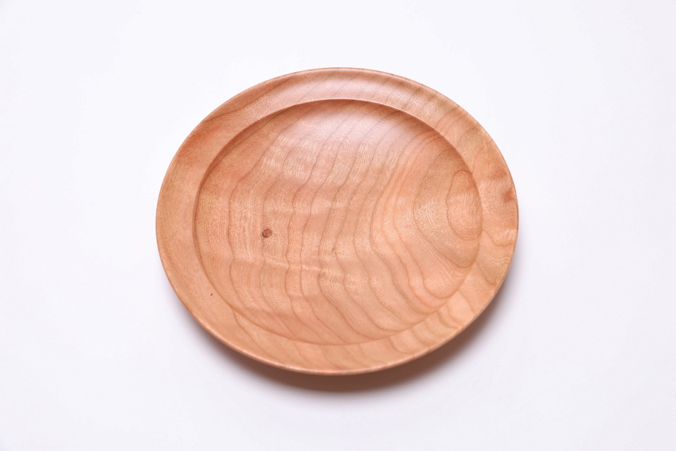 Detail of bud scar and quilted figure on handcrafted black cherry jewelry dish