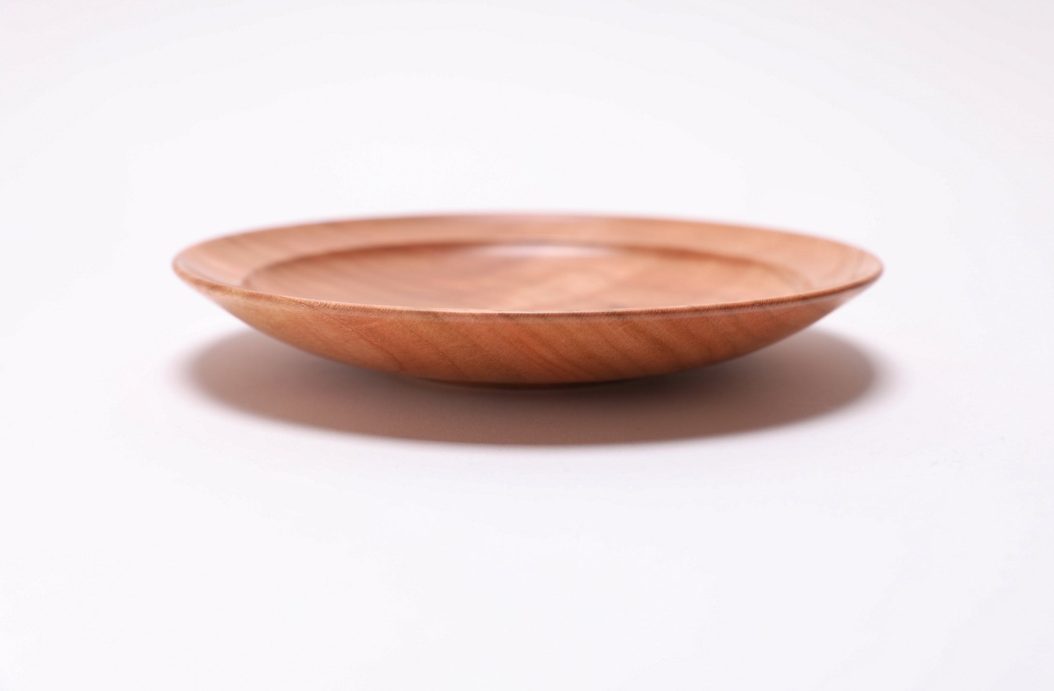 Side profile of wild black cherry ring dish, 6⅛ inches by 1 inch, handmade in North Carolina