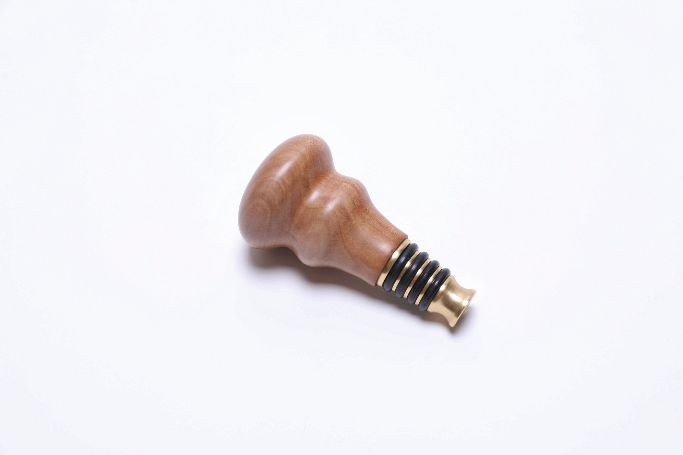 Handmade pear wood wine stopper with warm natural tones and food-safe oil finish