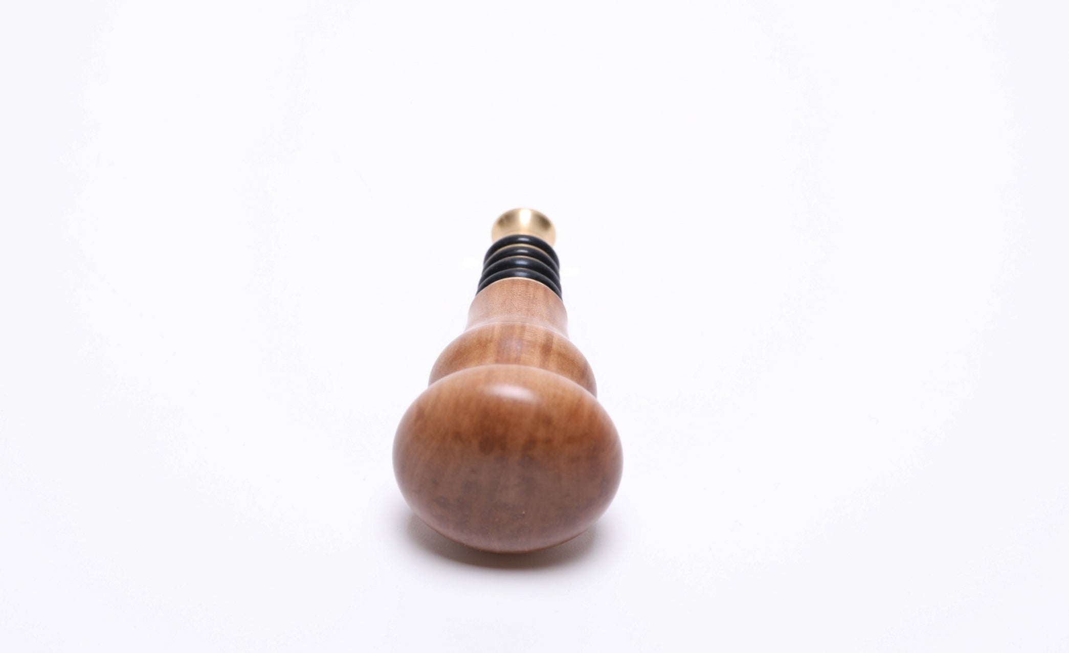 top view of handcrafted pear wood bottle stopper showing natural wood figure