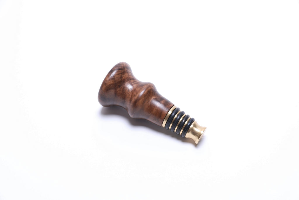 NC black walnut burl wine stopper, angled view highlighting burl grain pattern
