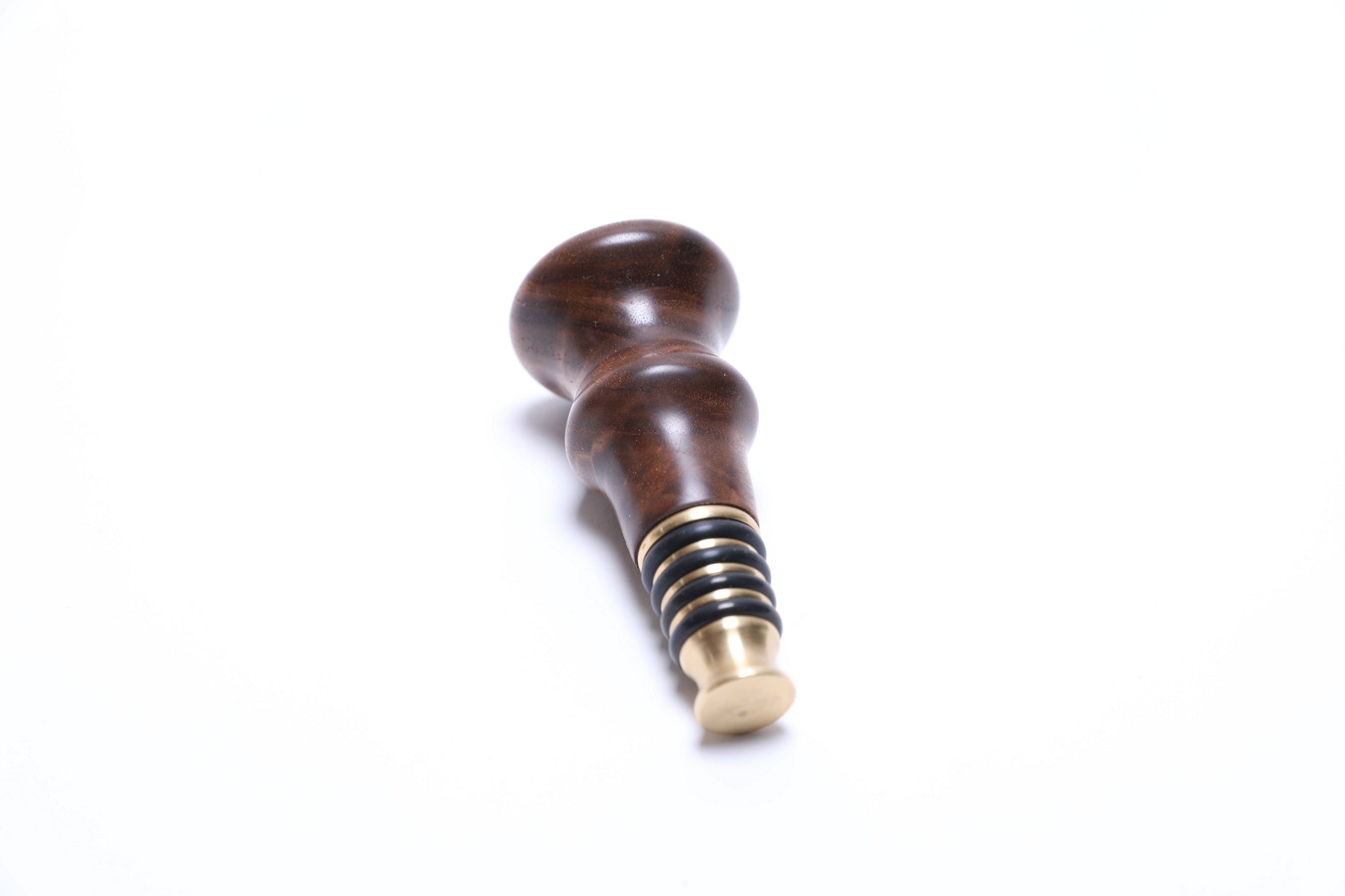 Black walnut crotch burl wine stopper, close-up of swirling wood figure