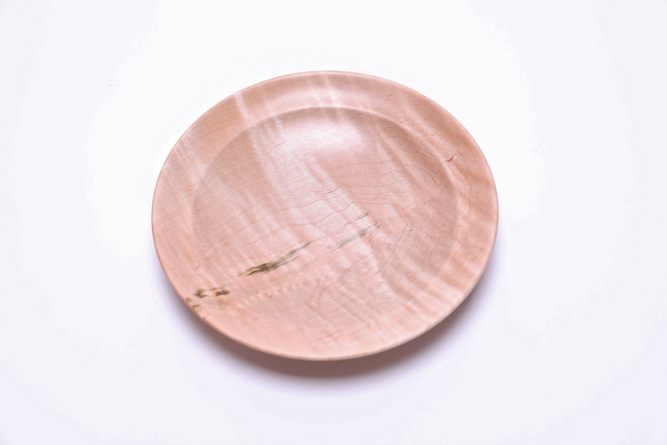 Handmade tiger maple ring dish, close-up of chatoyant figure in raking light