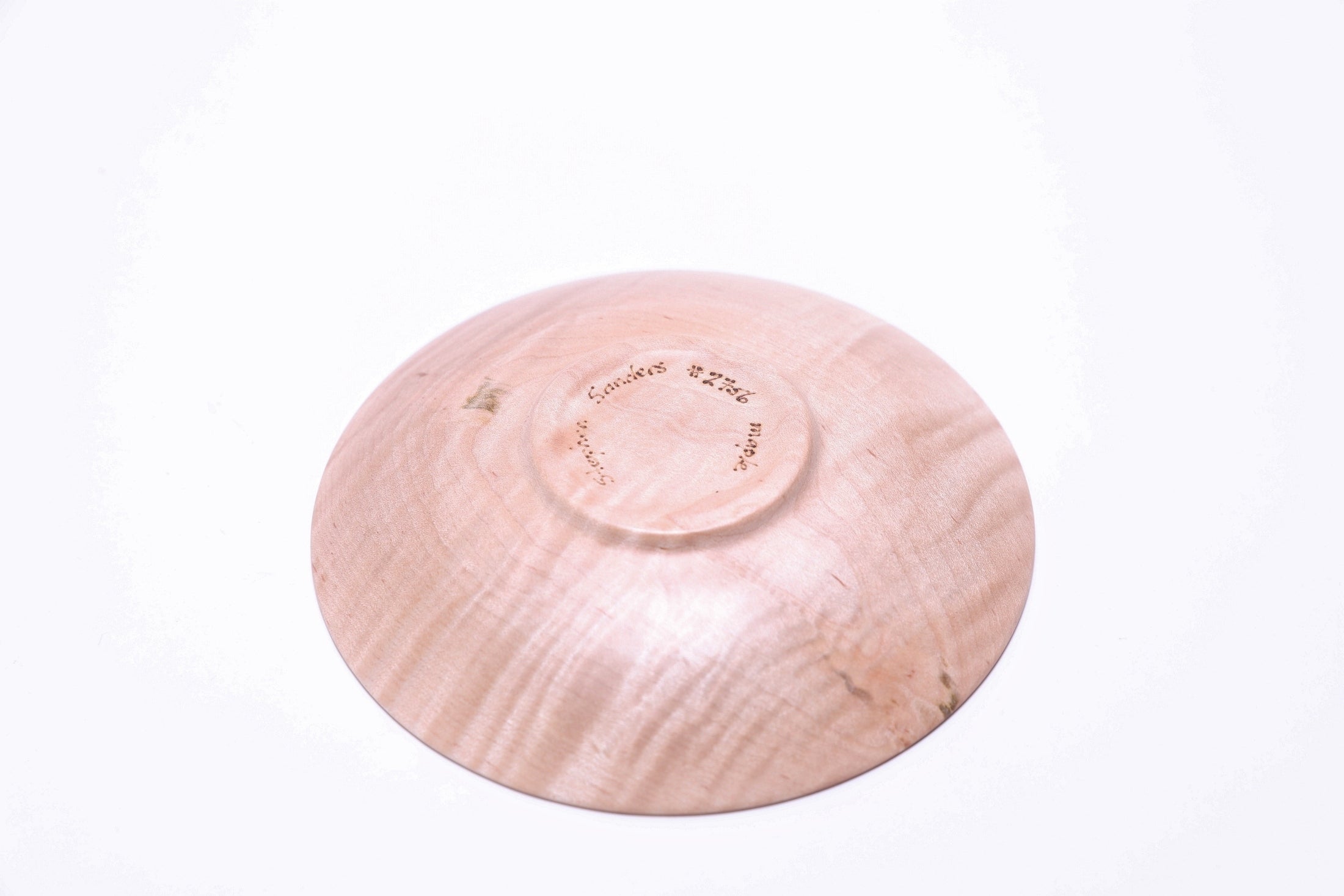 Tiger maple ring dish, bottom view showing raised foot
