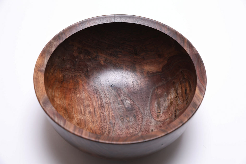 Handcrafted walnut bowl with rich dark chocolate and red highlight tones