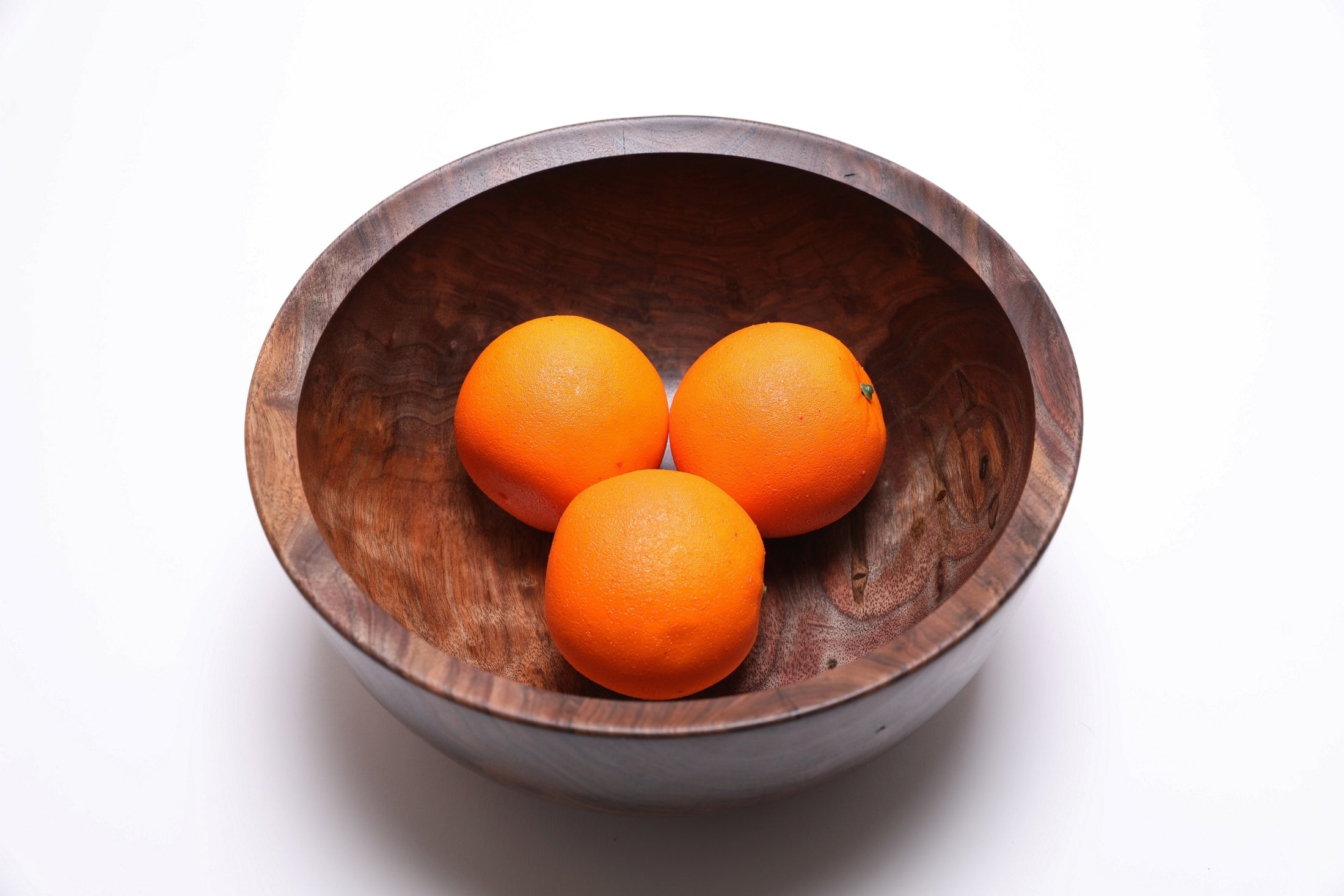 Spalted wild black walnut bowl, angled view showing bowl with three oranges