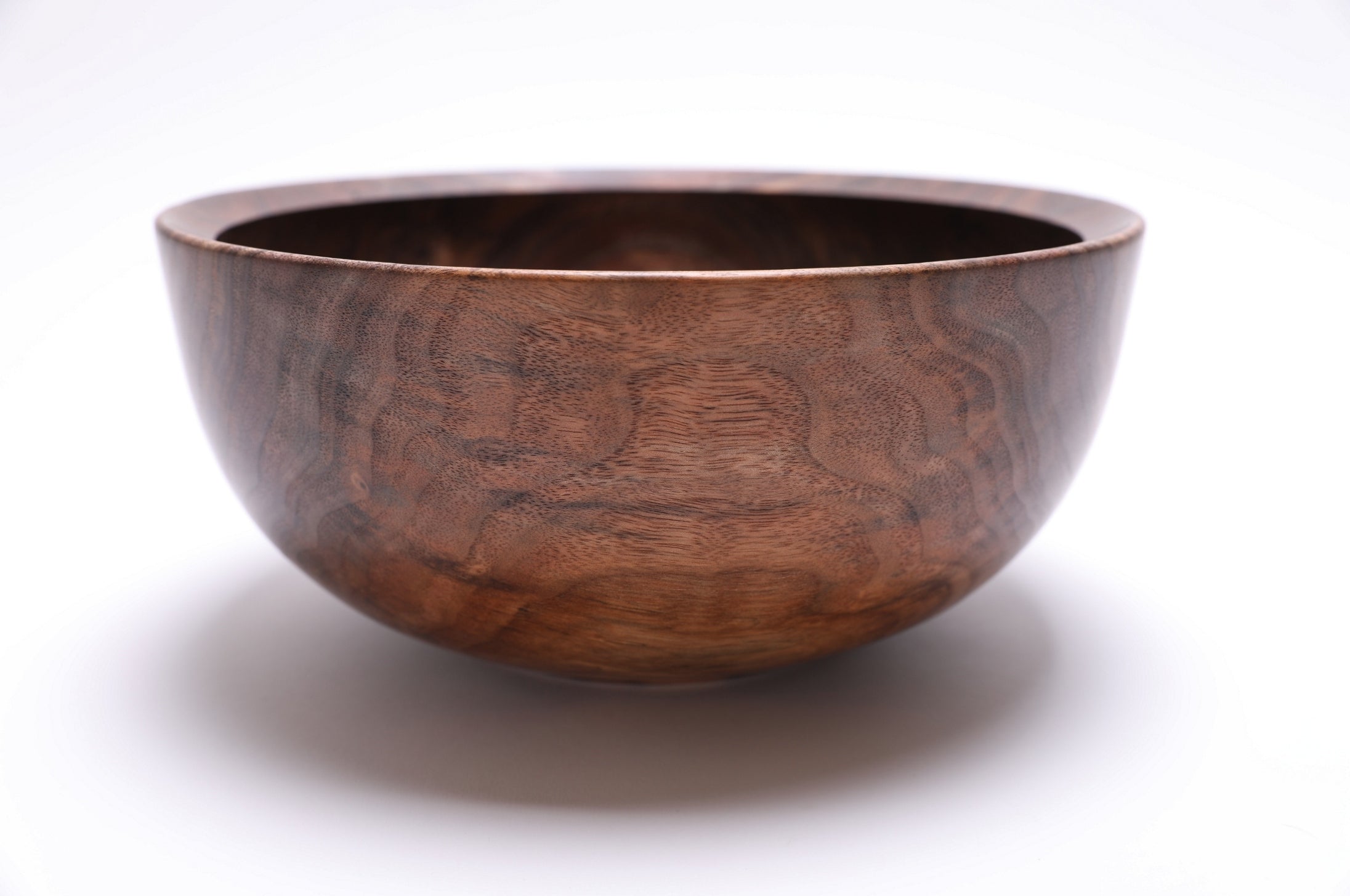 Wild black walnut bowl with spalting and curly growth rings, side profile