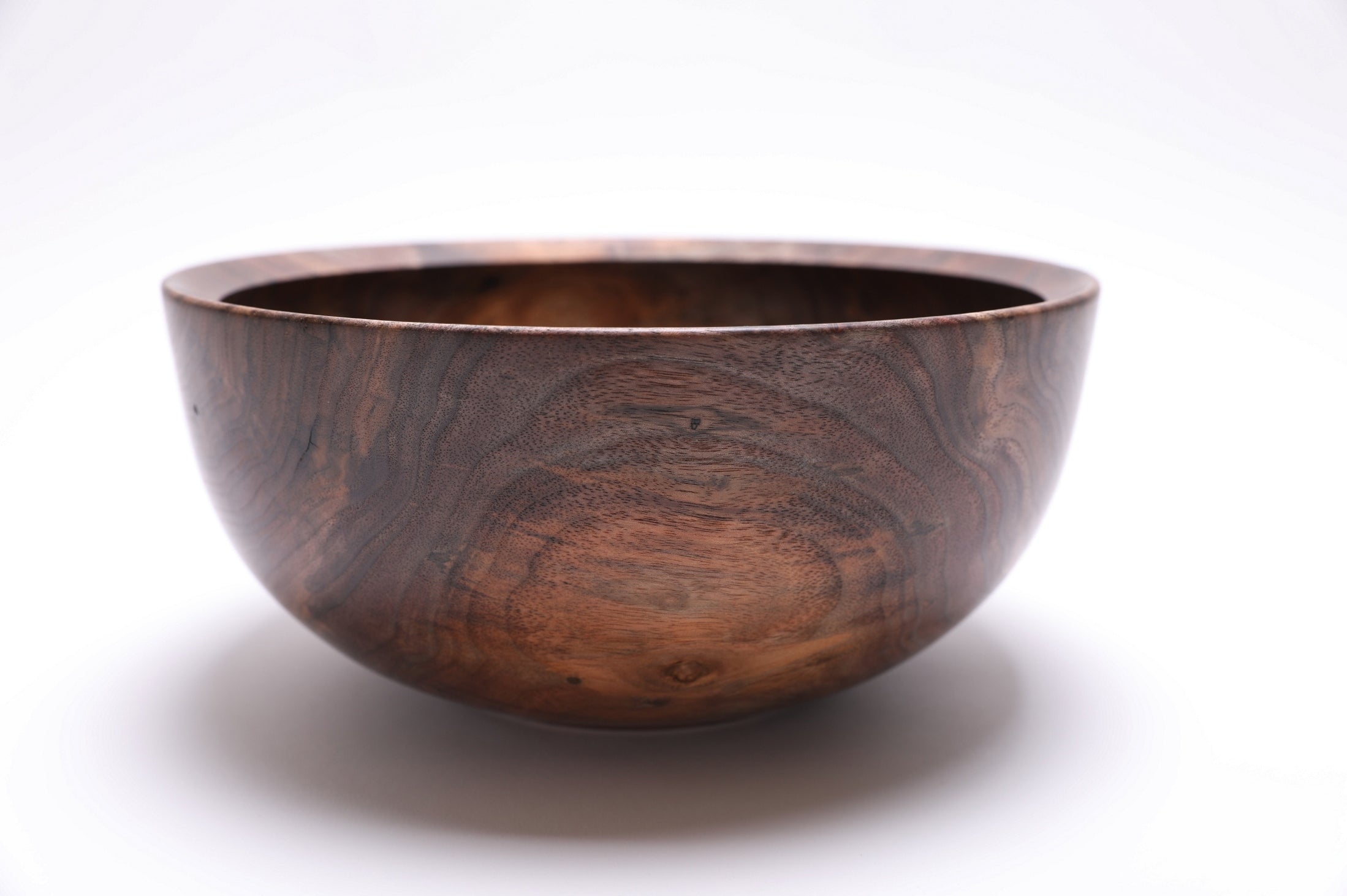 Spalted curly black walnut bowl, side view showing dramatic color from cream to dark chocolate